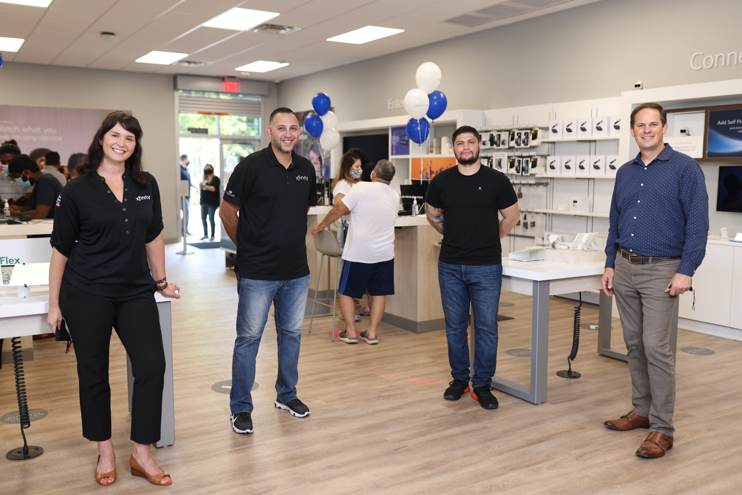 Xfinity team members standing inside an Xfinity Store.