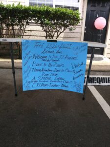 A blue sign taped to a table with positive writing and stating 2020-2021 School Year