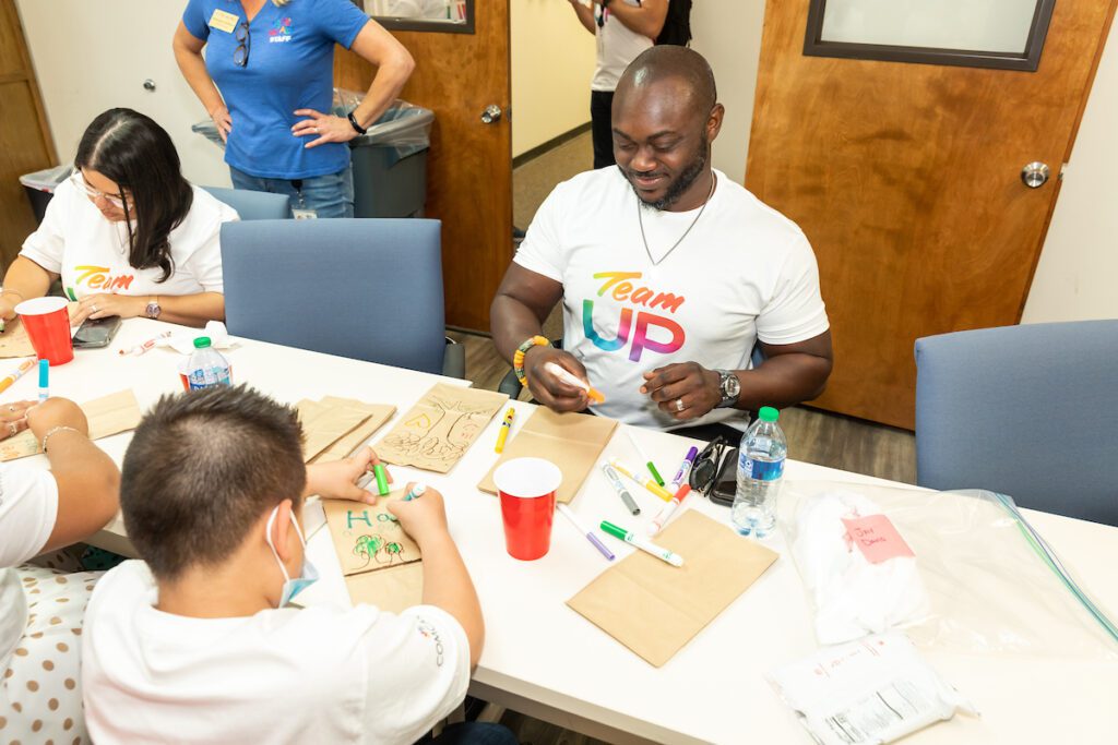 Volunteers decorating paper lunch bags