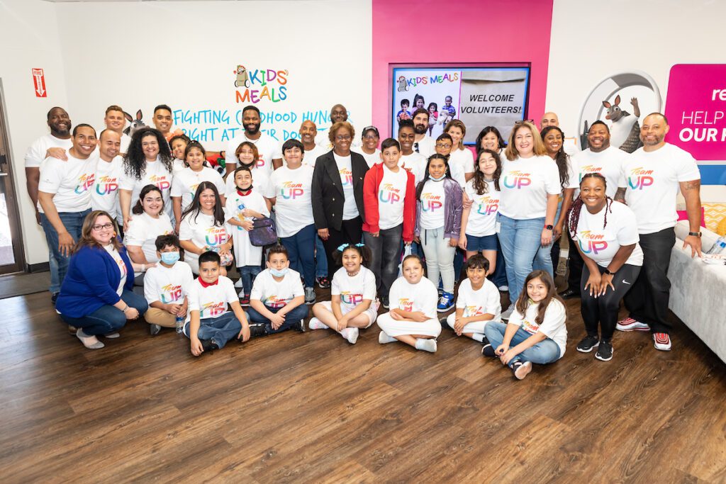 Large group of people wearing Team Up t-shirts posing for a picture