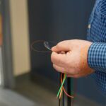 Close up on gentleman's hand holding cable fiber