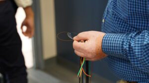 Close up on gentleman's hand holding cable fiber