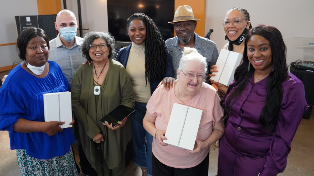 A group of event organizers and elderly posing for a picture