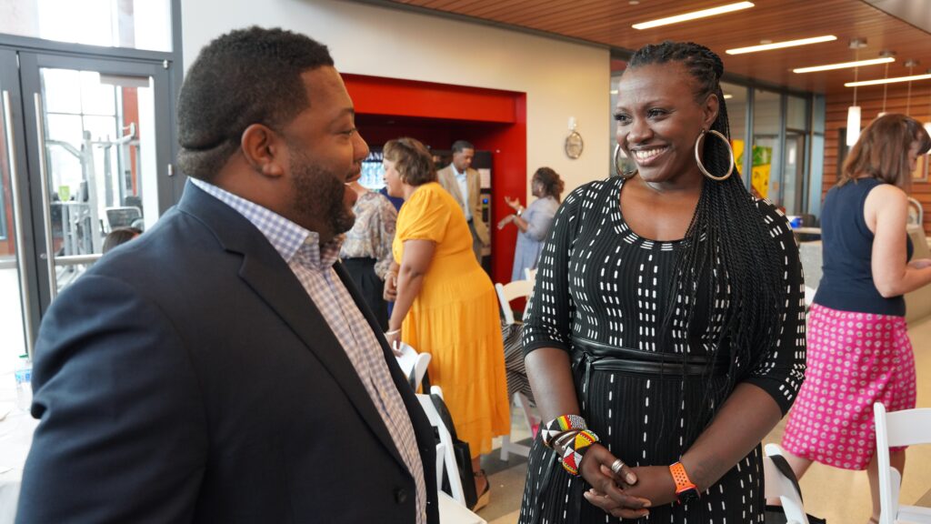 Two people smiling and chatting together