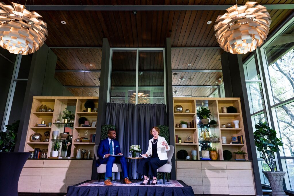 Moderator and Carol Eggert sitting on small stage