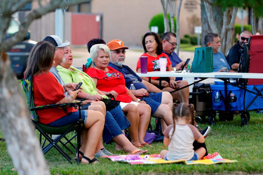 A group of people sitting in lawn chairs