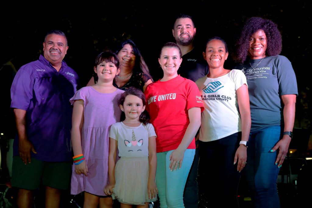 A group of people smiling and posing for a picture together