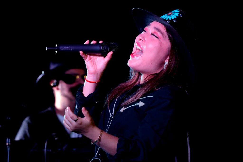 Close up on woman singing with eye closed