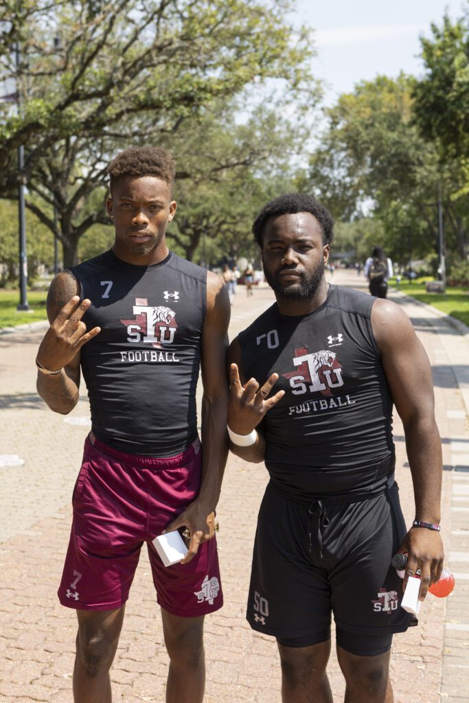 Two young men posing wearing TSU football shirts