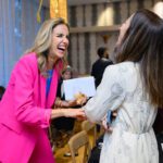 Two women laughing at event