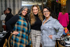 Three women smiling and posing for a picture