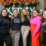 Group of five women posing together for picture