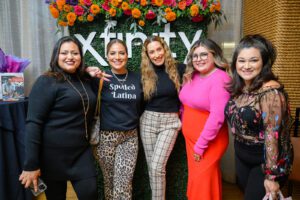 Group of five women posing together for picture