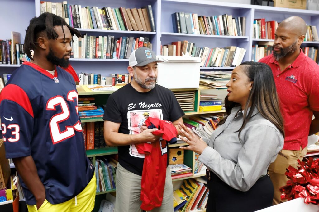 Group of volunteers speaking to each other in library