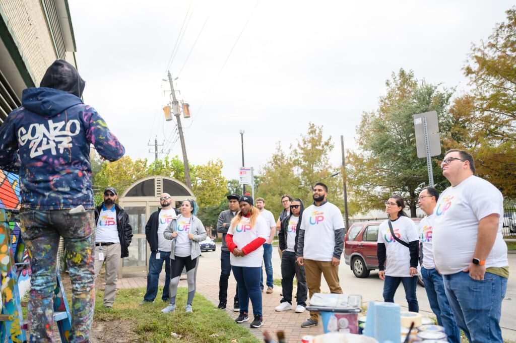 A group of volunteers listening to instruction