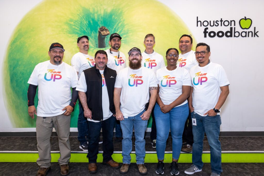 Group of Team Up volunteers posing for picture at Houston food bank.