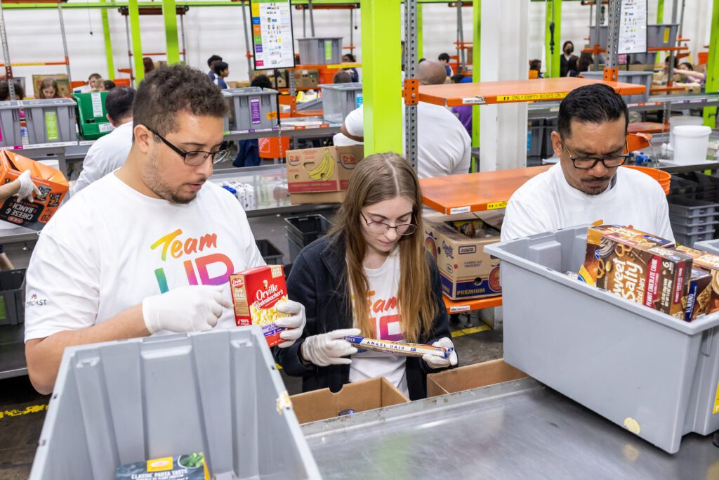 Team Up volunteers filling bins at Houston food bank.