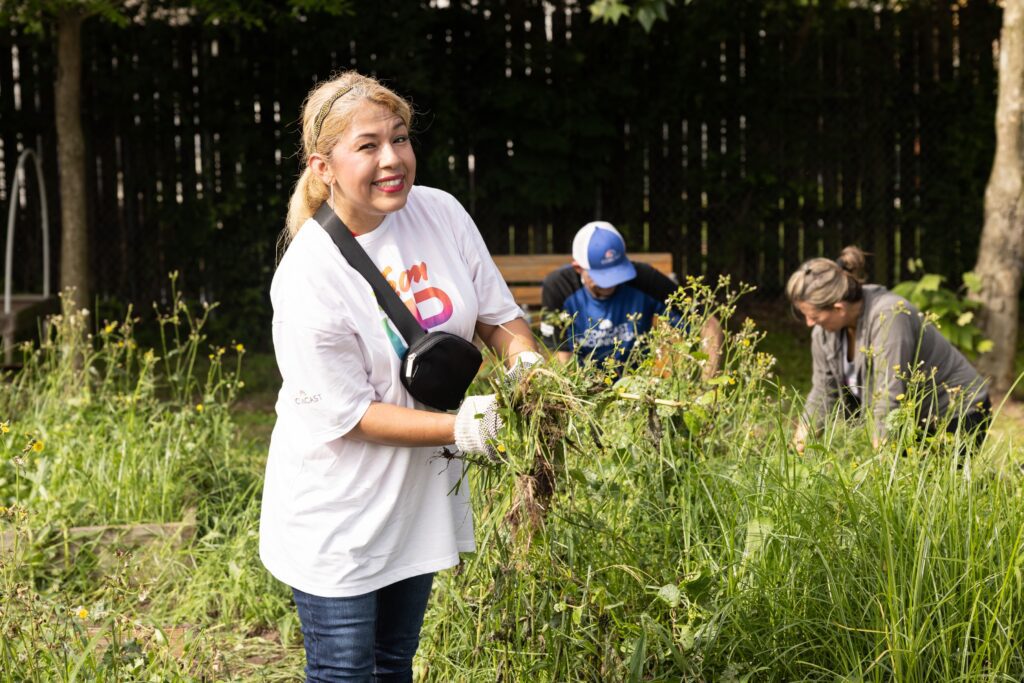 Smiling volunteer holding a handful of soil