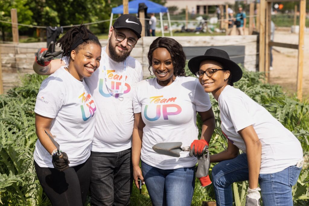 Four volunteers smiling and posing for picture together