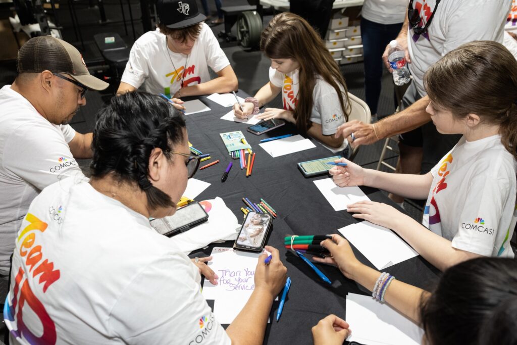 Team Up volunteers writing notes at a table