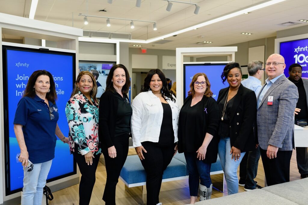 Guests posing for picture in Xfinity store.