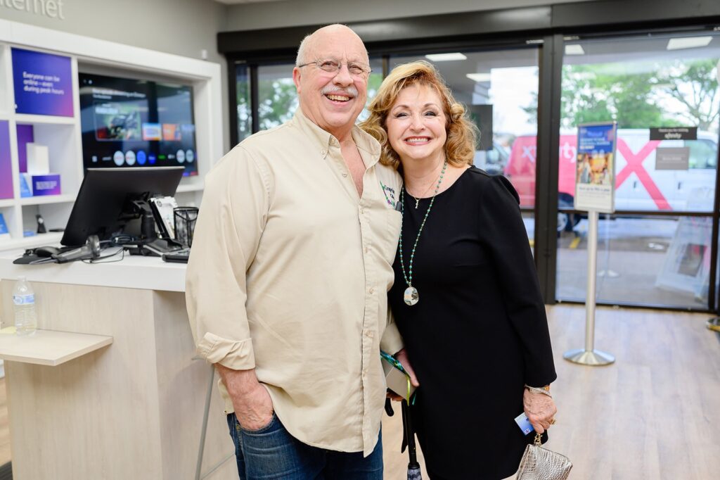 A man and woman posing for a picture together inside Xfininty store