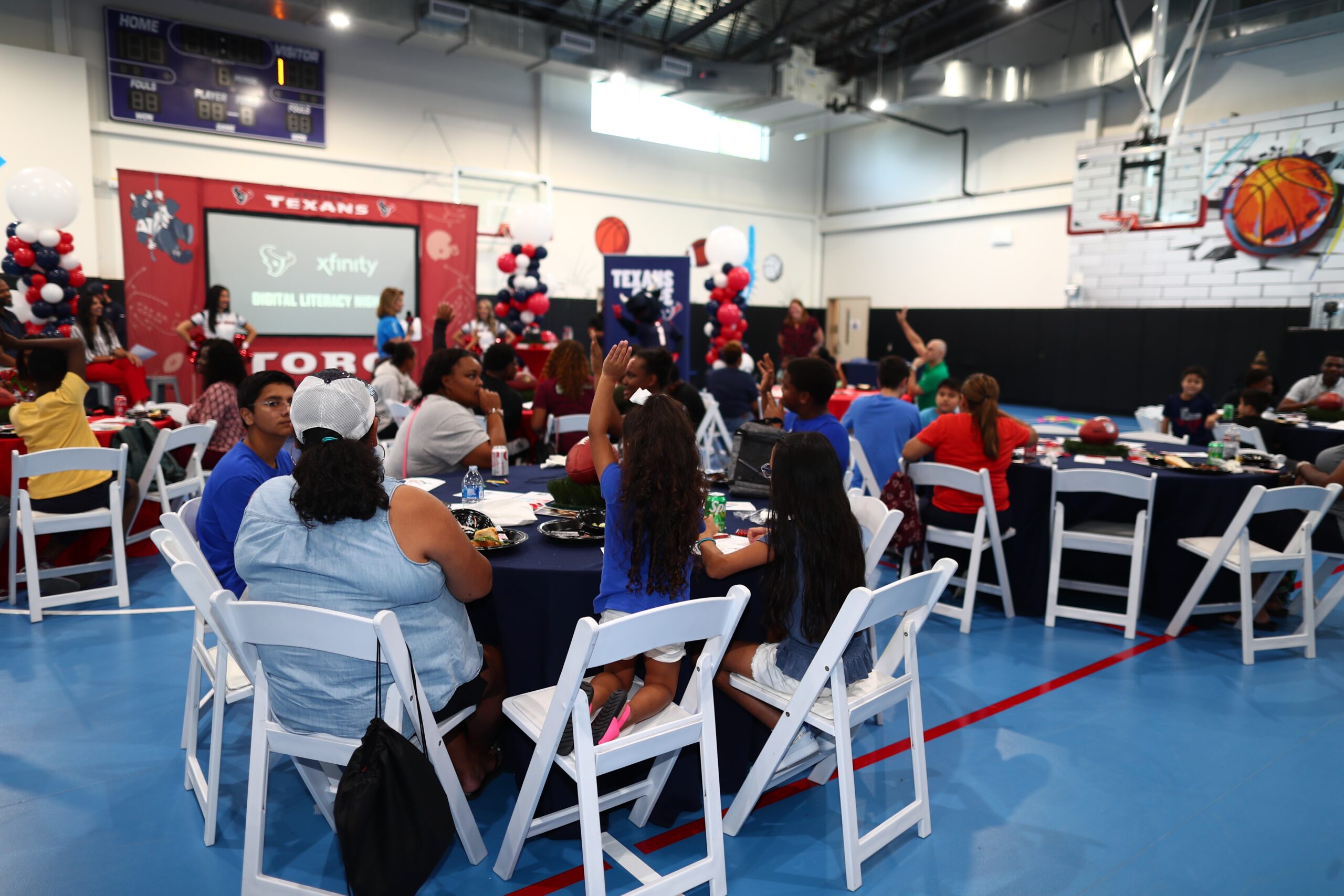 Attendees at Digital Literacy night seated at round tables.