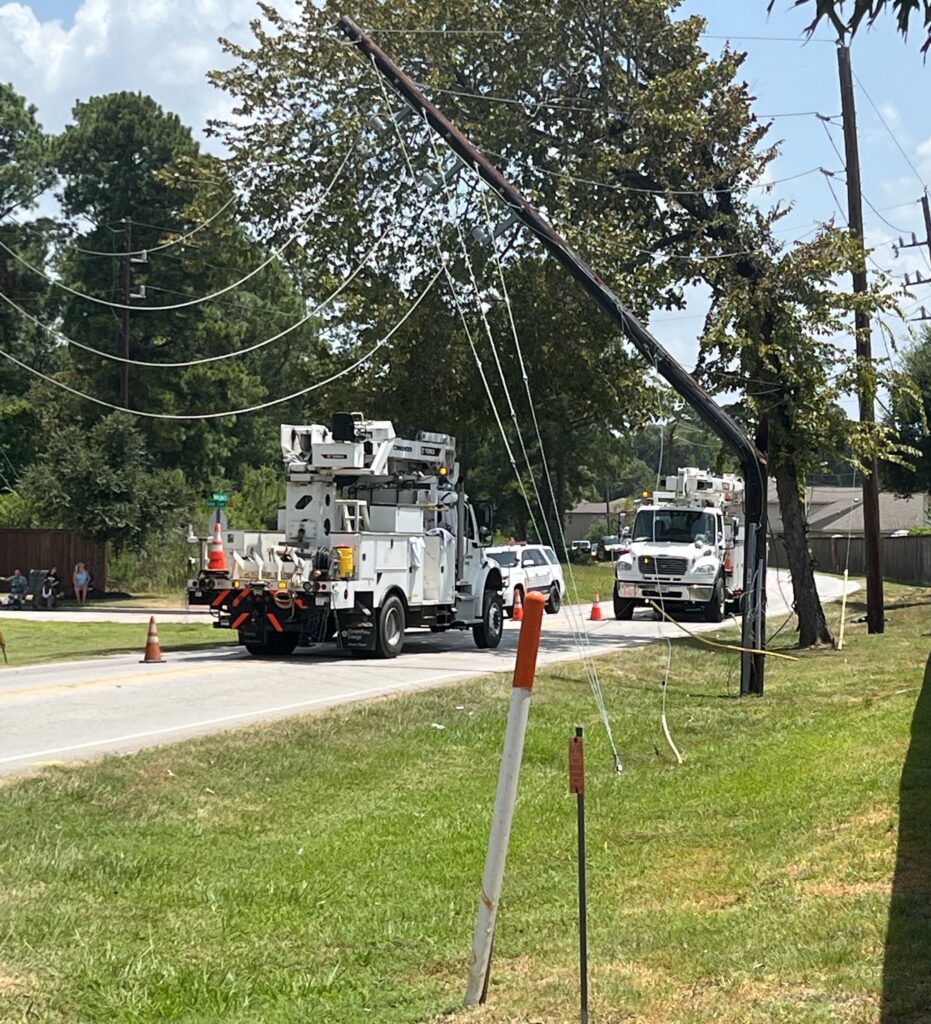 Trucks parked near downed power lines.