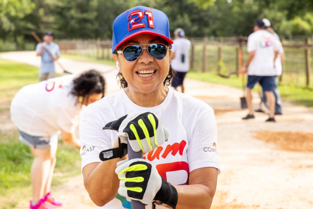 Team Up volunteer wearing sunglasses pauses to smile toward camera