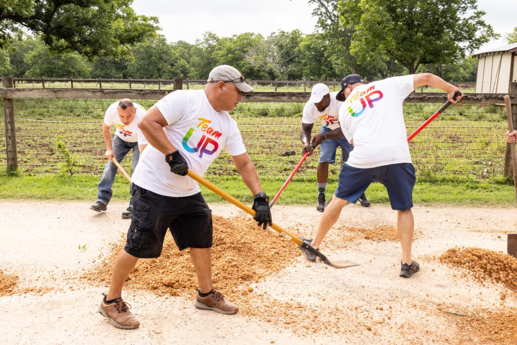 Team Up volunteers digging near the stable