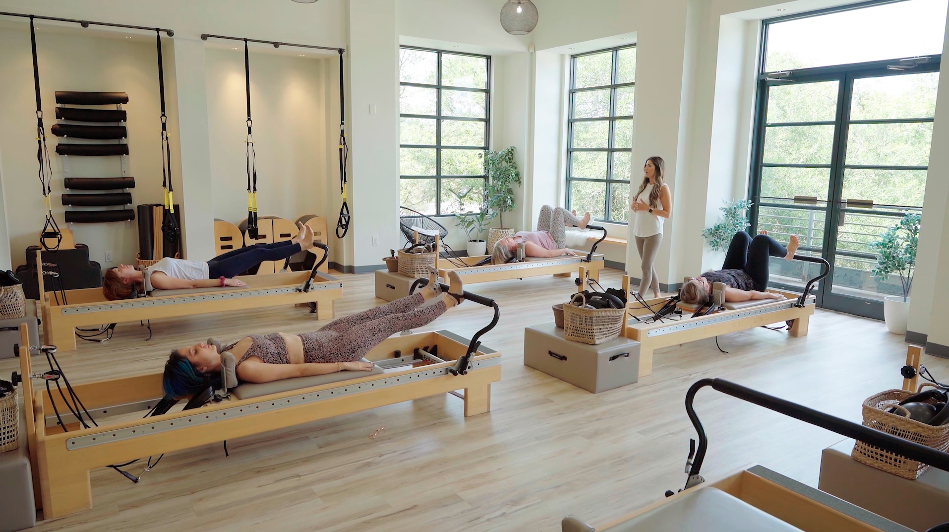 Women in pilates studio receiving instruction