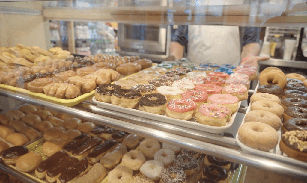 Display case full of of many varieties of doughnuts