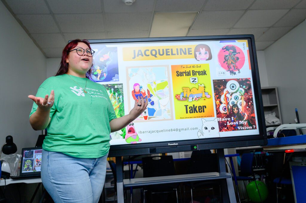 A student presents her designs at AAMA's Work and Learn Center