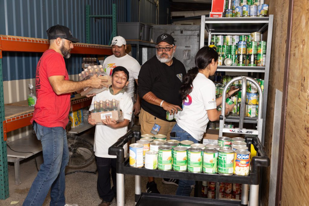 Volunteers work to stock the shelves at Camp Hope.