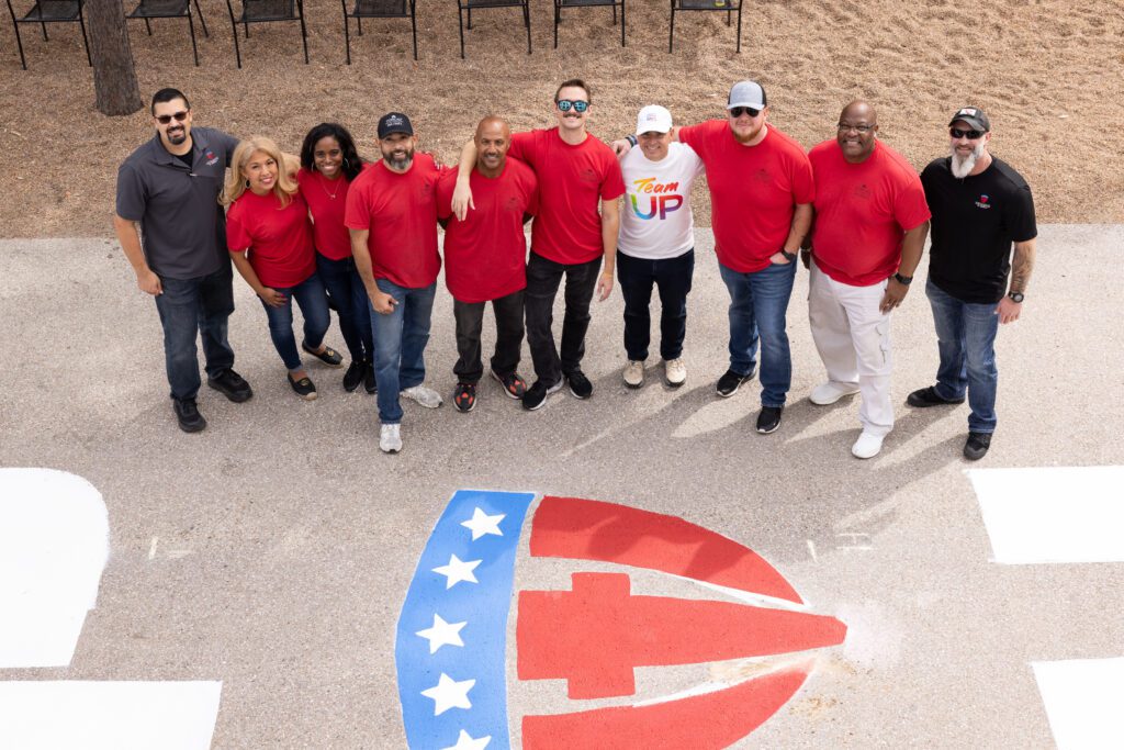 A group of volunteers smile for a photo at Camp Hope in Houston, Texas.