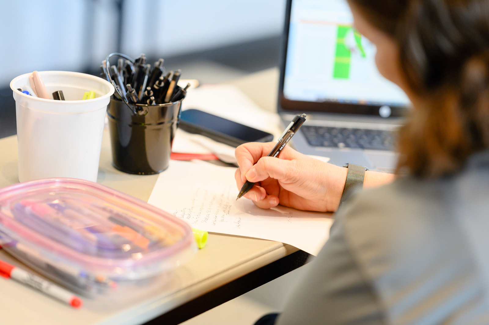 A young adults writes down tips during a Lift Zone Learning Series by Comcast.