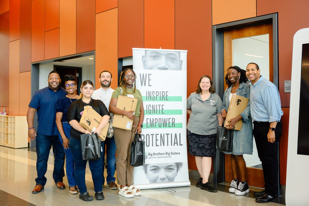 Participants smile after the learning session in a group photo.