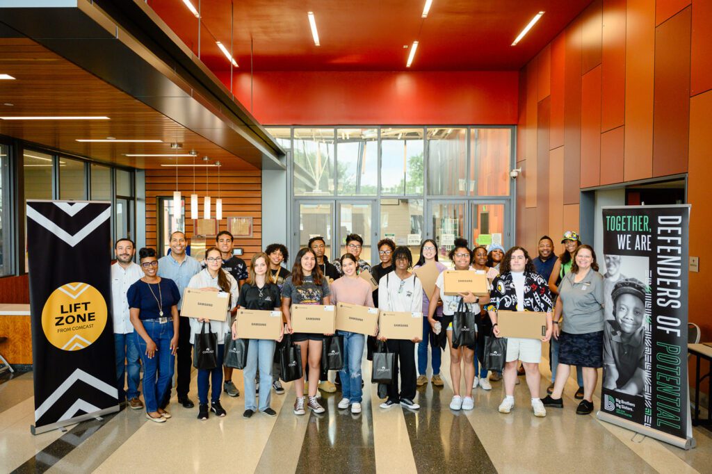 Participants from the learning session smile in a group photo. 