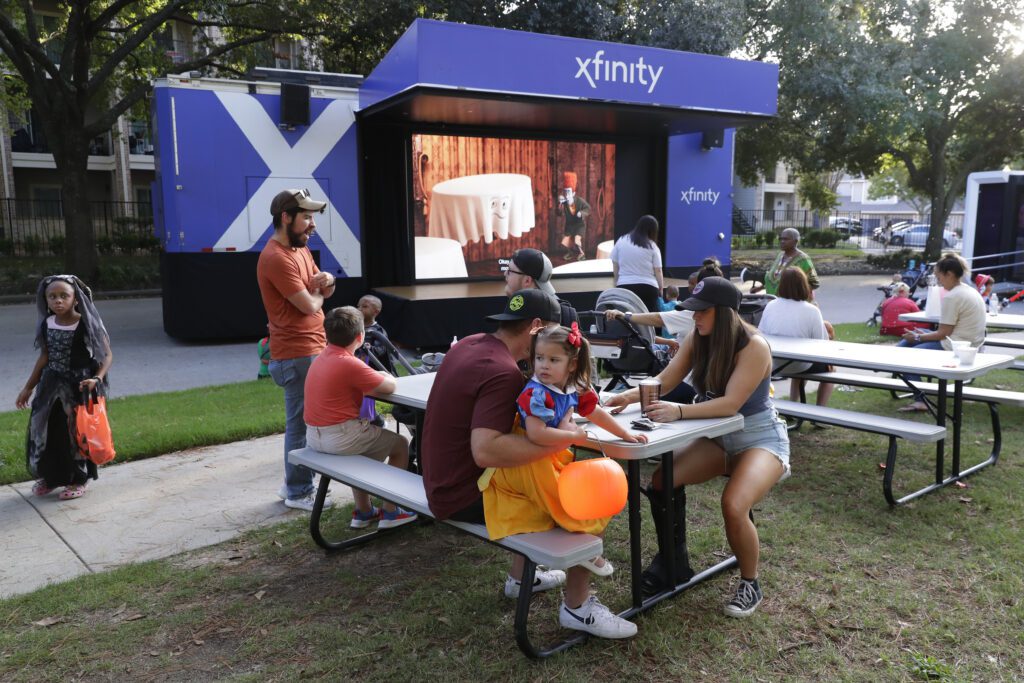 Attendees take photos in front of the Boofest sign at the pumpkin patch during the Comcast Kingwood Takeover, held at the Kingwood Town Center Park on Saturday, Oct. 28, 2023 in Kingwood, TX. (Michael Wyke/AP Images for Comcast)