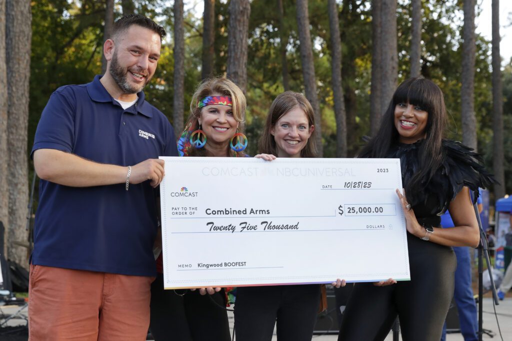 Check presentation ceremonies to beneficiaries by Comcast staff on the stage during the Comcast Kingwood Takeover, held at the Kingwood Town Center Park on Saturday, Oct. 28, 2023 in Kingwood, TX. (Michael Wyke/AP Images for Comcast)